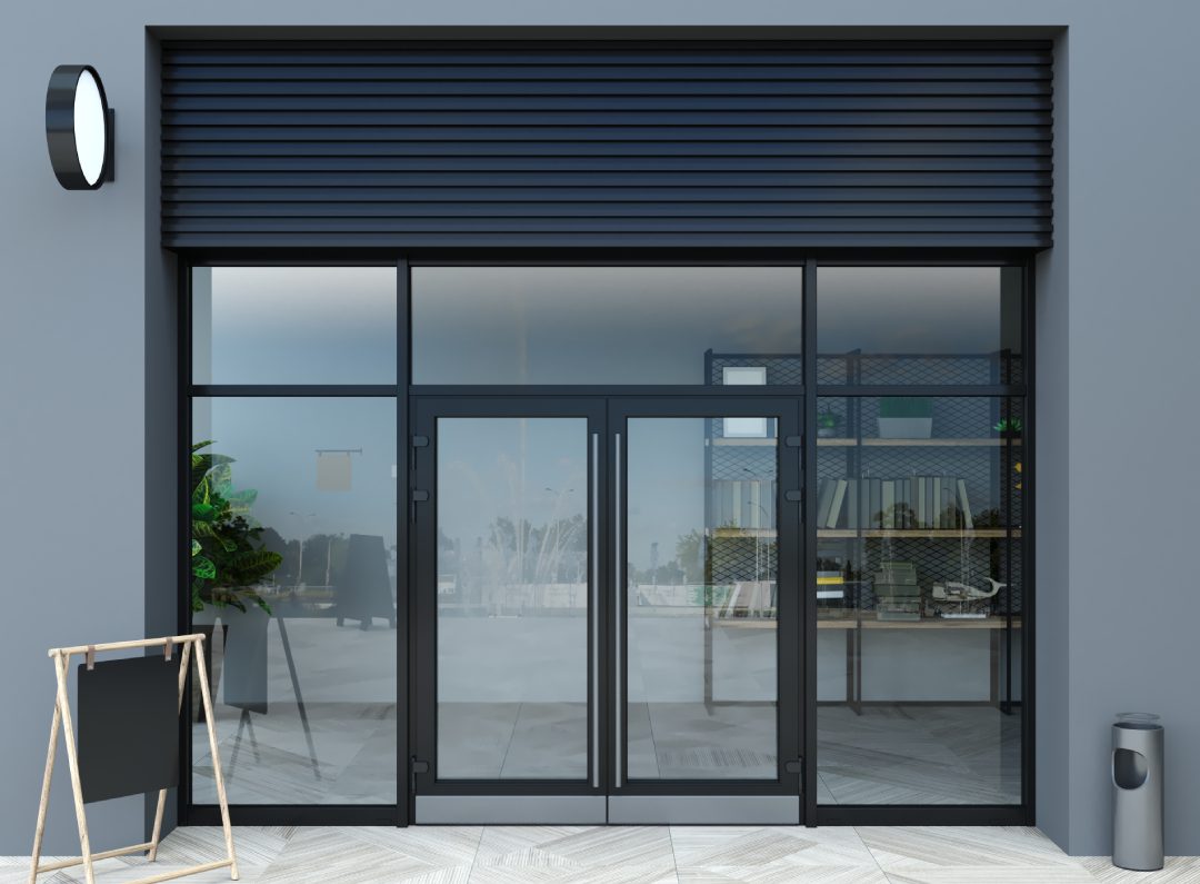 Closed glass entrance with a partially open metal shutter.