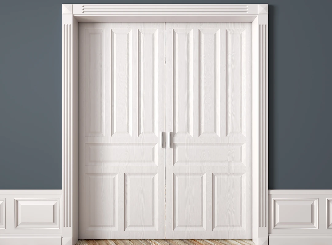 White double doors with decorative molding.