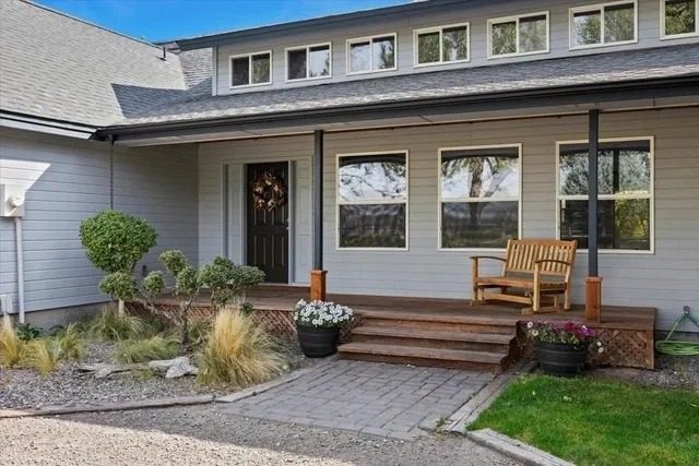 Modern house with porch and wooden bench.