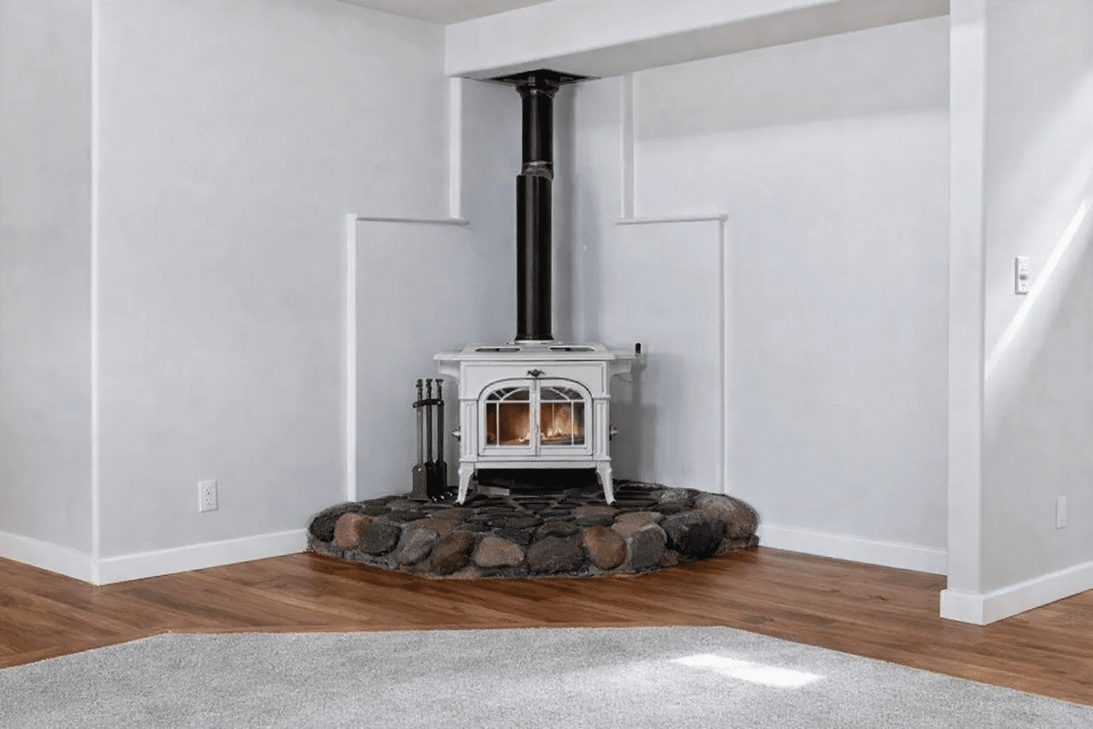Wood stove in a minimalist corner room.