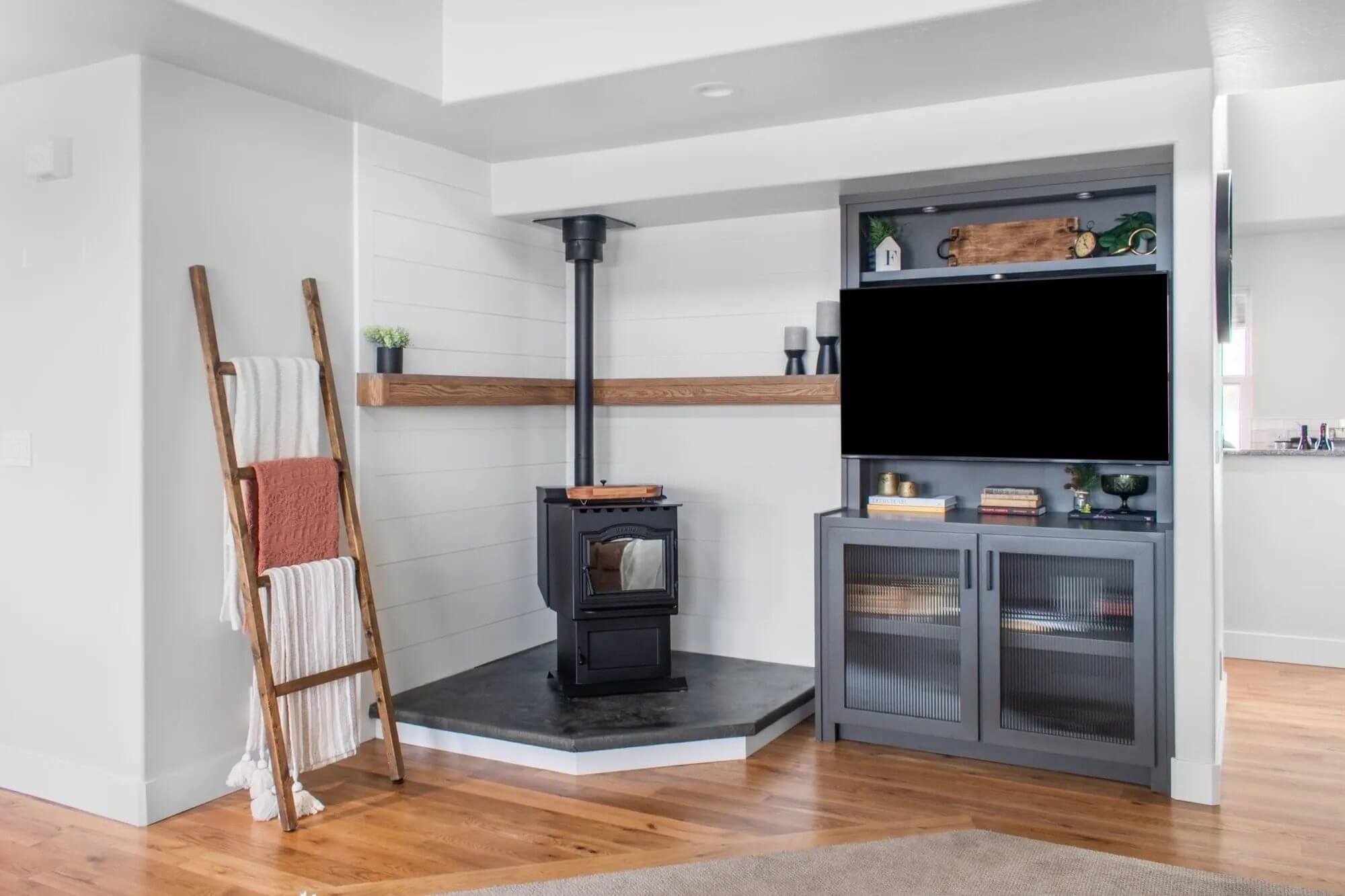 Modern living room with wood stove and decor.